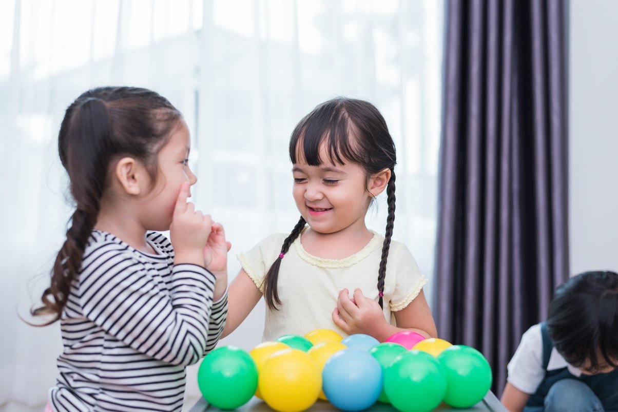 Two Little Girls Playing with Toys